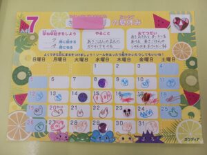 Colorful July calendar page for kids with handwritten doodles on many dates and fruit-themed border art across yellow background.